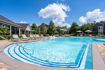 A large swimming pool with a blue tiled edge and a white line in the middle.